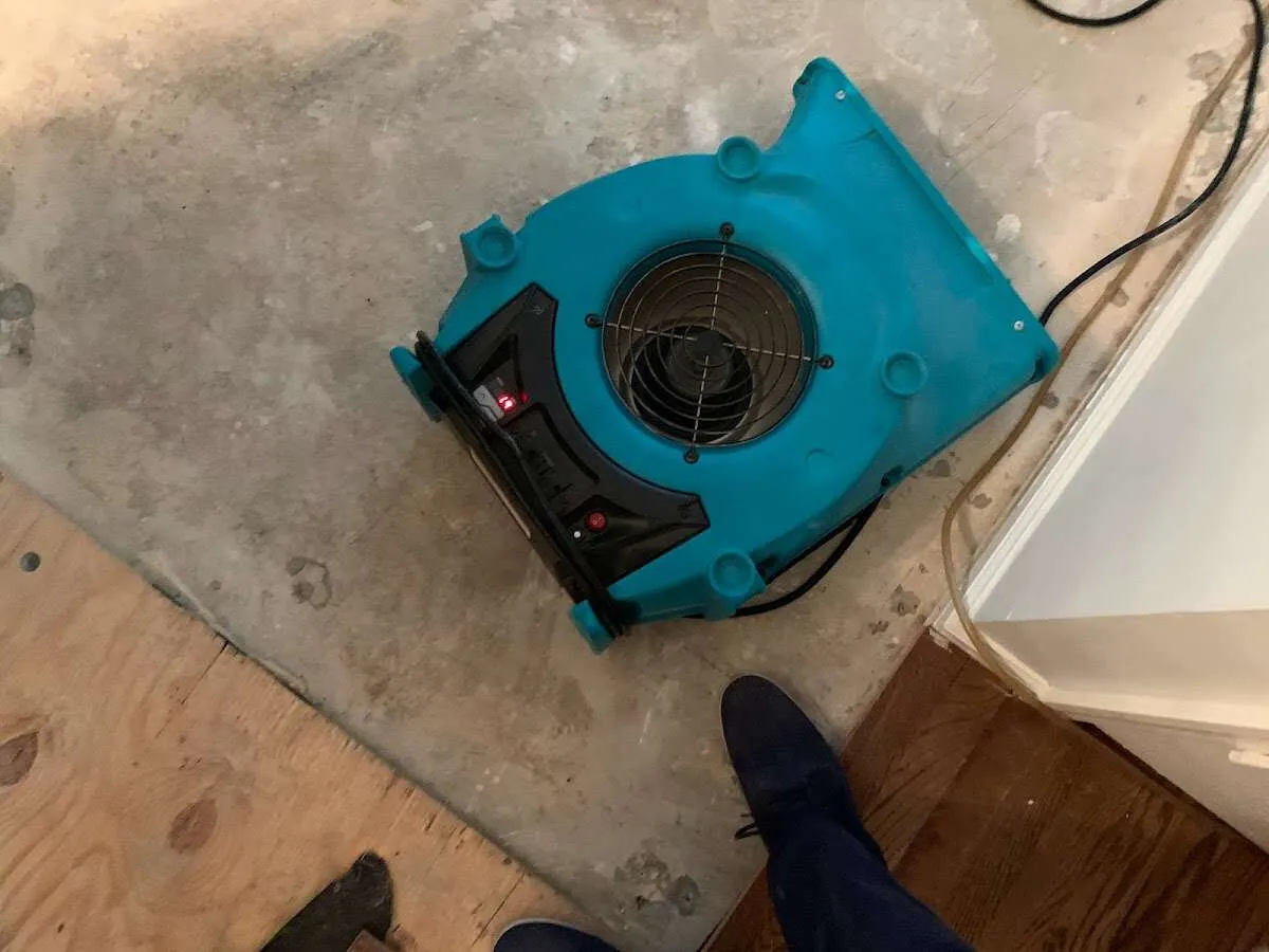 Air mover drying subfloor during Commercial Water Damage Restoration in Weehawken